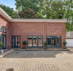 An outdoor area with brick walls and planters at The Cottage in Wimborne Minster
