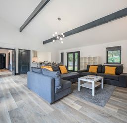 A living room with a sofa and coffee table at The Cottage in Wimborne Minster