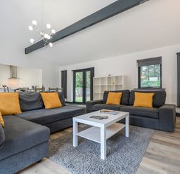 A living room with sofas and a coffee table at The Cottage in Wimborne Minster
