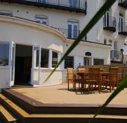 An outdoor dining area with a table and chairs at 11 Cove View Apartments in Ilfracombe