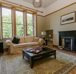 A living room with two sofas coffee table and a fireplace at The Residence in Cleator