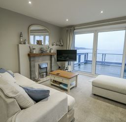 A living room with a sofa and television at White Sails Y Felinheli