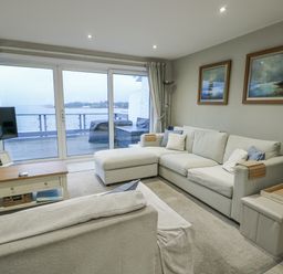 A living room with a sofa and television at White Sails Y Felinheli
