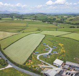 An aerial view of a rural area with fields and houses at Beech in Ulverston