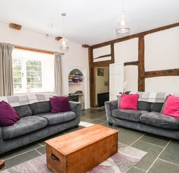 A living room with sofas and a coffee table at The Abbey Grange near Charmouth