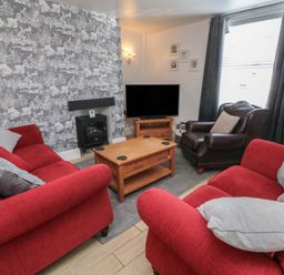 A living room with a sofa and coffee table at Bluebell Cottage in Flamborough