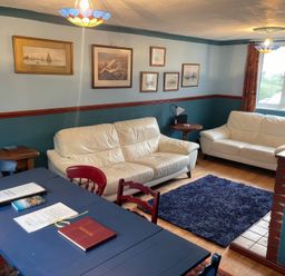 A living room with sofas and a table at 11 Penygroes in Llanddeusant