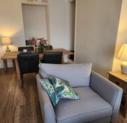 A dining room with a table and chairs at 8 Arvonia Terrace Cricieth