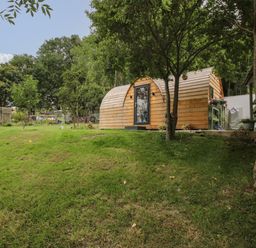 A wooden pod room near trees and grass at The Pod in Worthen near Minsterley