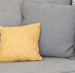 Two cushions on a grey fabric sofa at Finch 59 in Cayton