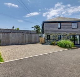 An outdoor area with a house and driveway at Sandy Cove, Praa Sands