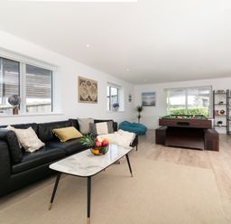 A living room with a pool table and seating area at Sandy Cove in Praa Sands