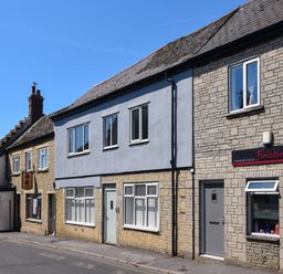 A street view of buildings including a hairdressing salon and a restaurant in Ayla Lyme Regis