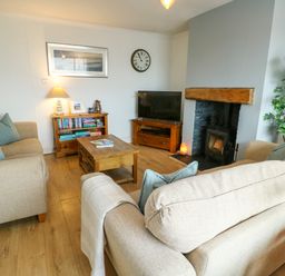 A living room with sofa and fireplace at Valley Pines in Valley