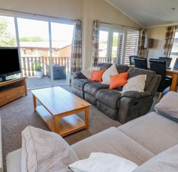 A living room with sofas a coffee table dining table and television at Gressingham 22 South Lakeland Leisure Village