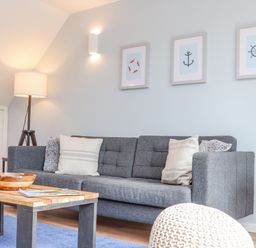 A living room with a gray sofa cushions a wooden coffee table and a floor lamp at Helford in Mawnan Smith Near Falmouth
