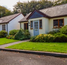 Two single story houses with pitched roofs and shrubs in front at Lilyvale Davidstow near Camelford