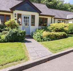 A house with a blue door and gardens at Lilyvale in Davidstow near Camelford