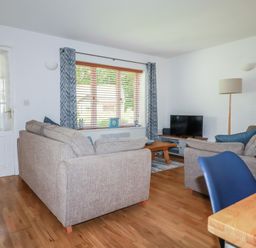 A living room with a sofa and television at Lilyvale in Davidstow near Camelford