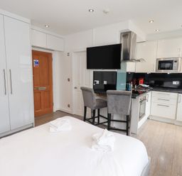 A studio with a bed and kitchen area at Bowness Central in Bowness-On-Windermere