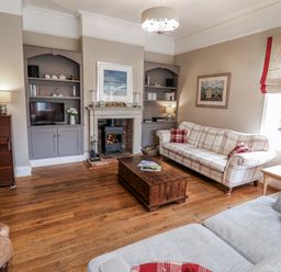 A living room with a sofa and coffee table at Holly Lodge in Aldeburgh