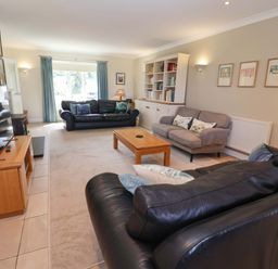 A living room with seating and a television at Seadrift in Dunwich Near Westleton