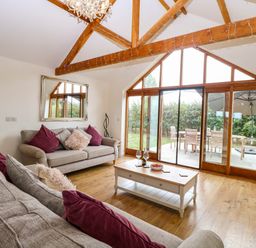 A living room with sofas and a coffee table at The Mulberry, nr Bungay