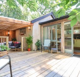An outdoor area with seating and kitchen view at Yew Tree Farm Barn and Stable Framlingham