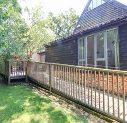 A decking area leading to a building at Yew Tree Farm Barn and Stable Framlingham