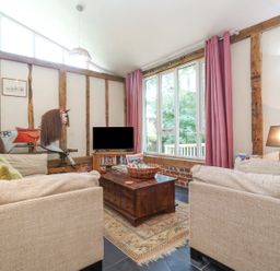 A living room with a coffee table and a television at Yew Tree Farm Barn and Stable in Framlingham