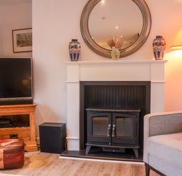 A living room with a sofa and television at Pine Cottage in Woodbridge