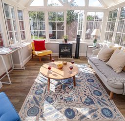 A conservatory with furniture and decor at The Round House in Easton near Framlingham