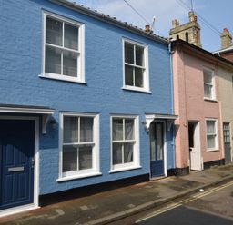 A row of attached two story houses with doors and windows on a street at 53 Tern Cottage Aldeburgh