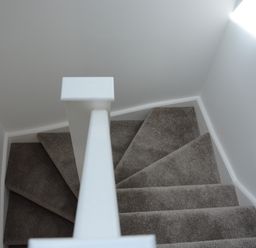 A carpeted staircase with a white handrail and gray walls at Bramertons Nest Long Melford