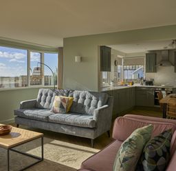 A living room with a sofa and coffee table at Harbour Lights in Southwold