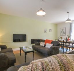 A living room with sofas coffee table and dining table with chairs at The Gallery Blythburgh near Southwold