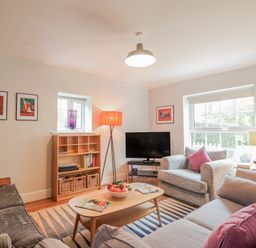 A living room with a sofa and coffee table at Fig Cottage, Pettistree Near Woodbridge