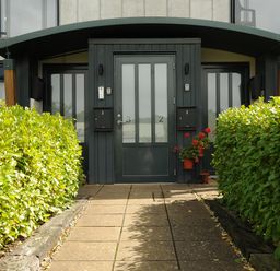 An entrance with two doors numbered 2 and 3 with mailboxes and plants on either side at Bluebell Retreat in Lostwithiel