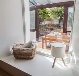 A dining room window with a basket and lamp at Candle Croft in Tolgus Mount near Redruth