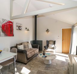 A living room with a sofa and coffee table at Bottom Lodge in Penhow