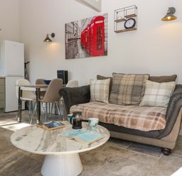 A living room with a sofa and coffee table at Bottom Lodge in Penhow
