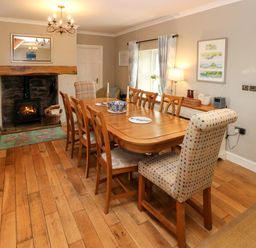 A dining room with a table and chairs at North Studdock Cottage Angle near Pembroke