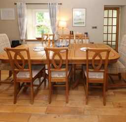 A dining room with a table and chairs at North Studdock Cottage Angle near Pembroke