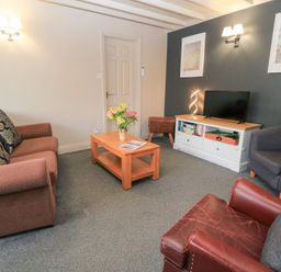 A living room with sofas and a coffee table at Paddock Cottage Nr Malmesbury