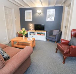 A living room with a sofa and coffee table at Paddock Cottage Nr Malmesbury