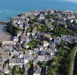 An aerial view of a coastal village with houses and a small harbor at Honey Cottage in Port Isaac
