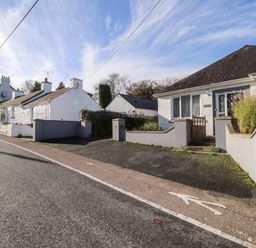 A street with white houses and a small fenced front yard at The Croft in Newport Pembrokeshire