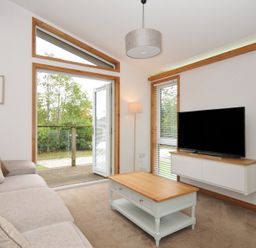 A living room with a sofa and television at 3 Southern Place in Dobwalls