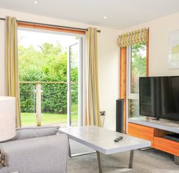 A living room with a TV and coffee table at 5 Faraway Fields in Dobwalls