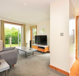 A living room with a television and sofa at 5 Faraway Fields in Dobwalls